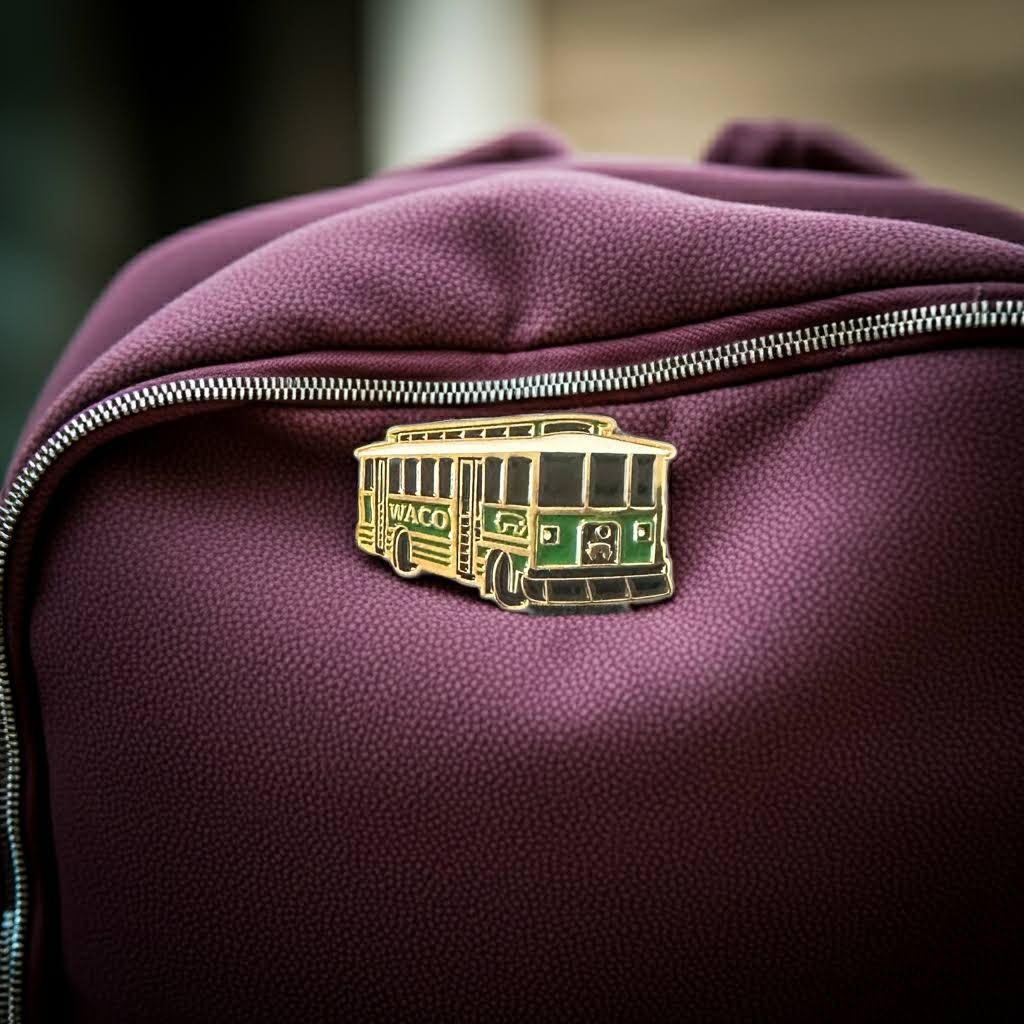 Purple bag with a green and gold trolley pin on a blurred background